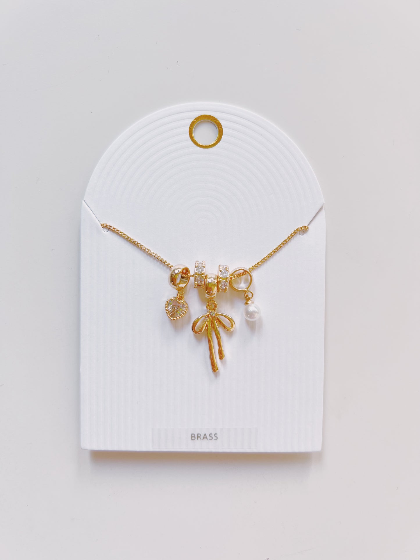 Gold Bow Multi Charm Necklace